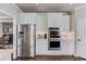 Modern kitchen featuring stainless steel appliances and custom white cabinetry at 1175 Lamont Cir, Dacula, GA 30019