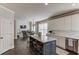 Open-concept kitchen island with seating and stainless steel dishwasher at 1175 Lamont Cir, Dacula, GA 30019