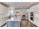 This kitchen features white cabinets, hardwood floors, a kitchen island, stainless steel appliances, and a window at 1175 Lamont Cir, Dacula, GA 30019