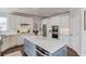 This kitchen features white cabinets, hardwood floors, a kitchen island, stainless steel appliances, and an outside view at 1175 Lamont Cir, Dacula, GA 30019