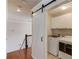 Laundry room with new washer and dryer behind a sliding barn door at 1175 Lamont Cir, Dacula, GA 30019