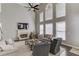 The living room has a fireplace, tall windows, hardwood floors, a ceiling fan, and a seating area at 1175 Lamont Cir, Dacula, GA 30019