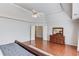 Bright main bedroom featuring wood floors, tray ceilings, ceiling fan, and a wood dresser with mirror at 1175 Lamont Cir, Dacula, GA 30019