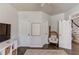 A comfortable sitting area features hardwood floors, white doors, and a charming woven chair at 1175 Lamont Cir, Dacula, GA 30019