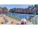 Community tennis courts with shaded seating areas and well-maintained green spaces for an active lifestyle at 1175 Lamont Cir, Dacula, GA 30019