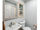 Cozy bathroom featuring a white vanity, decorative mirror and ample lighting at 1959 Grand Prix Ne Dr, Atlanta, GA 30345
