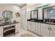 Bright bathroom featuring dual sinks, stylish mirrors, and a vanity area at 1959 Grand Prix Ne Dr, Atlanta, GA 30345