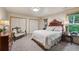 Tranquil bedroom with neutral tones, comfortable queen bed, and ample closet space at 1959 Grand Prix Ne Dr, Atlanta, GA 30345