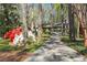 Long driveway leading to home surrounded by mature trees and azaleas at 1959 Grand Prix Ne Dr, Atlanta, GA 30345