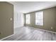 Bedroom featuring neutral walls, wood-look floors, two windows, and a closet with paneled doors, offering storage solutions at 845 Regal Path Ln, Decatur, GA 30030