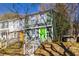 Two-story townhome with green siding and a bright green front door at 845 Regal Path Ln, Decatur, GA 30030