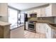 Modern kitchen featuring white cabinets, granite countertops, and stainless steel appliances at 845 Regal Path Ln, Decatur, GA 30030