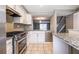 Kitchen with stainless steel appliances, granite countertops, and open floorplan view to living room and stairs at 845 Regal Path Ln, Decatur, GA 30030