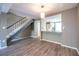 Living room with a view to the kitchen and featuring wood-look flooring and staircase at 845 Regal Path Ln, Decatur, GA 30030