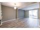 Open concept living room with modern gray walls, and sliding doors to the backyard at 845 Regal Path Ln, Decatur, GA 30030