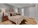 Comfortable bedroom with hardwood floors, a queen-size bed, and a view of the outdoors from the window at 1233 Poplar Grove Ne Dr, Atlanta, GA 30306