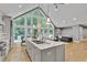 Kitchen features gray cabinets, granite countertops, stainless steel appliances, a large picture window, and open living area at 1233 Poplar Grove Ne Dr, Atlanta, GA 30306