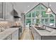 Bright kitchen features gray cabinets, granite countertops, stainless steel appliances, and large picture window with outside view at 1233 Poplar Grove Ne Dr, Atlanta, GA 30306