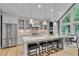 Bright kitchen boasts gray cabinets, granite countertops, stainless steel appliances, island with seating, and adjacent dining area at 1233 Poplar Grove Ne Dr, Atlanta, GA 30306