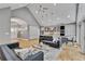 Open floorplan connects the living room with modern sofas to a spacious kitchen and dining area with natural light at 1233 Poplar Grove Ne Dr, Atlanta, GA 30306