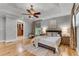 Serene bedroom with a tray ceiling, ceiling fan, hardwood floors, ensuite bath and a walk-in closet at 1233 Poplar Grove Ne Dr, Atlanta, GA 30306