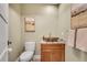 Stylish powder room features a vessel sink, wooden cabinet, and decorative artwork at 1233 Poplar Grove Ne Dr, Atlanta, GA 30306