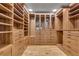 Spacious walk-in closet boasts custom wood shelves and drawers, providing ample storage and organization at 1233 Poplar Grove Ne Dr, Atlanta, GA 30306