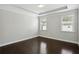 Bright bedroom features a trey ceiling, hardwood floors, and bright windows offering ample natural light at 1829 Hislop Ln, Atlanta, GA 30345