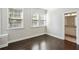Bright bedroom with hardwood floors, two windows, and en-suite bathroom access at 1829 Hislop Ln, Atlanta, GA 30345