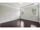 Bedroom with hardwood floors, neutral paint, tray ceilings and two large windows with blinds at 1829 Hislop Ln, Atlanta, GA 30345