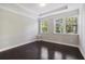 Bedroom features hardwood floors, a tray ceiling, and two large windows with blinds at 1829 Hislop Ln, Atlanta, GA 30345