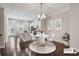 Dining room with contemporary lighting, dark wood floors and an eat-in kitchen with stainless appliances at 1829 Hislop Ln, Atlanta, GA 30345