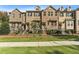 Exterior shot of red brick townhomes with black fences and landscaped front yards at 1829 Hislop Ln, Atlanta, GA 30345