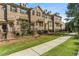 Exterior shot of red brick townhomes with black fences and landscaped front yards at 1829 Hislop Ln, Atlanta, GA 30345