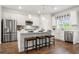 Bright kitchen with white cabinets, stainless steel appliances, and an island with bar stools at 3190 Eastham Run Dr, Dacula, GA 30019
