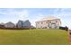 Expansive green backyard with grass lawn, privacy fence, and multi-story house with multiple windows at 3314 Ridge Manor Way, Dacula, GA 30019