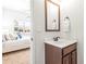 Bathroom featuring a view of a bedroom, wood vanity, and a mirror at 3314 Ridge Manor Way, Dacula, GA 30019