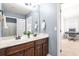 Bathroom with dual sinks and dark wood cabinets, a plant for decor, and blue painted walls at 3314 Ridge Manor Way, Dacula, GA 30019