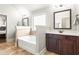 Bright bathroom with a soaking tub, dark wood vanity, and neutral toned tile flooring at 3314 Ridge Manor Way, Dacula, GA 30019