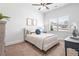 Cozy bedroom featuring carpeted floor, white walls, ceiling fan, and a bed with a blue accent pillow at 3314 Ridge Manor Way, Dacula, GA 30019