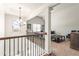 Second floor bonus room with a chandelier, railing, and comfortable seating area at 3314 Ridge Manor Way, Dacula, GA 30019