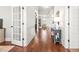 Elegant hallway with hardwood floors, white wainscoting, and open doorway at 3314 Ridge Manor Way, Dacula, GA 30019
