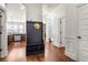 Hallway featuring a built-in bench, hardwood floors, and arched doorways at 3314 Ridge Manor Way, Dacula, GA 30019