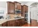 Gourmet kitchen features granite counters, stainless appliances, and rich wood cabinetry at 3314 Ridge Manor Way, Dacula, GA 30019