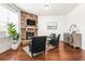 Comfortable living room offers a stone fireplace, hardwood floors, and a serene atmosphere at 3314 Ridge Manor Way, Dacula, GA 30019