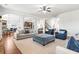 Open-concept living room with hardwood floors, plush seating, and elegant archways at 3314 Ridge Manor Way, Dacula, GA 30019