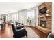 Cozy living room showcasing a stone fireplace, hardwood floors, and an abundance of natural light at 3314 Ridge Manor Way, Dacula, GA 30019