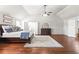 Expansive main bedroom boasts vaulted ceiling, hardwood floors, and ensuite bathroom access at 3314 Ridge Manor Way, Dacula, GA 30019