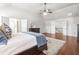 Open main bedroom with hardwood floors, king bed, and vaulted ceilings at 3314 Ridge Manor Way, Dacula, GA 30019