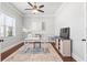The home office features large windows, neutral paint, modern furniture, and hardwood flooring at 3314 Ridge Manor Way, Dacula, GA 30019